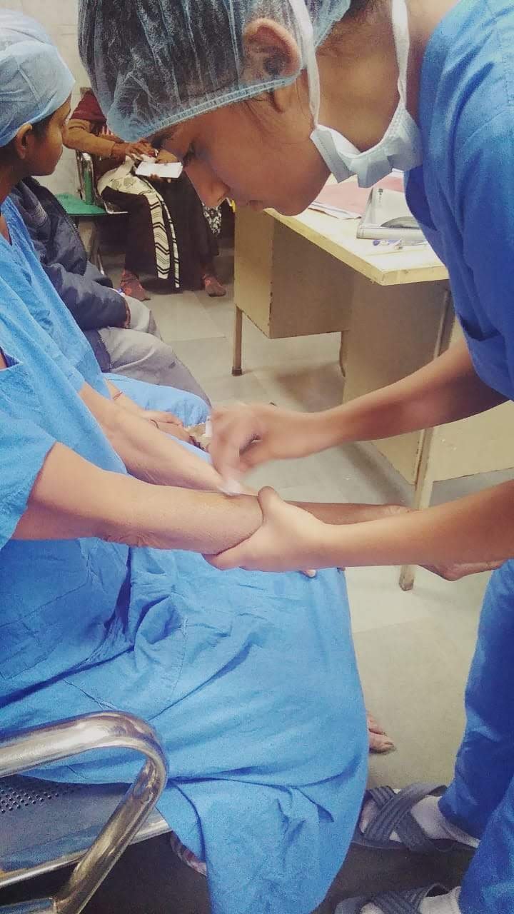 MedicoAtHome nurse administering care at a patient outreach camp